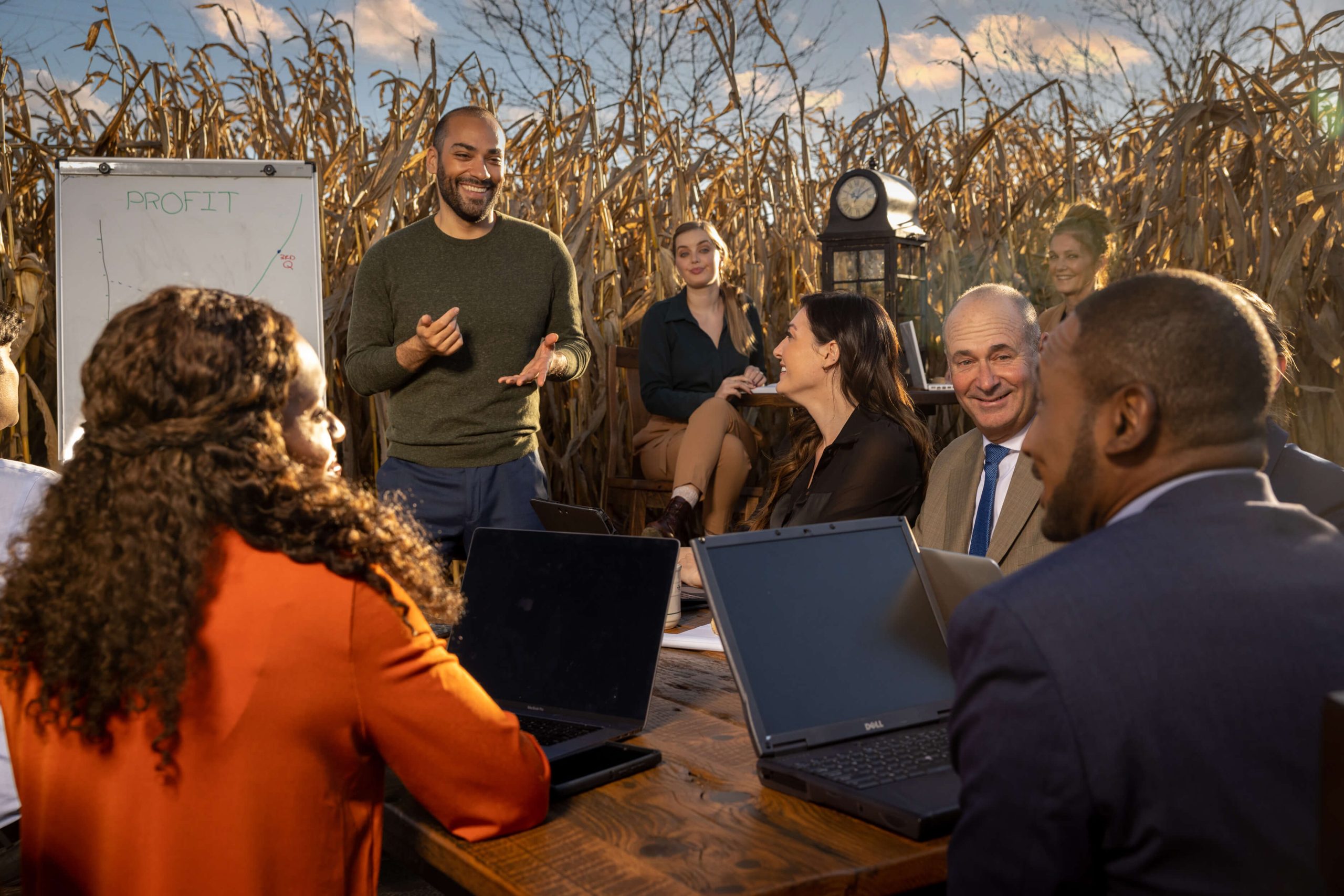 interactive group business meeting in a cornfield