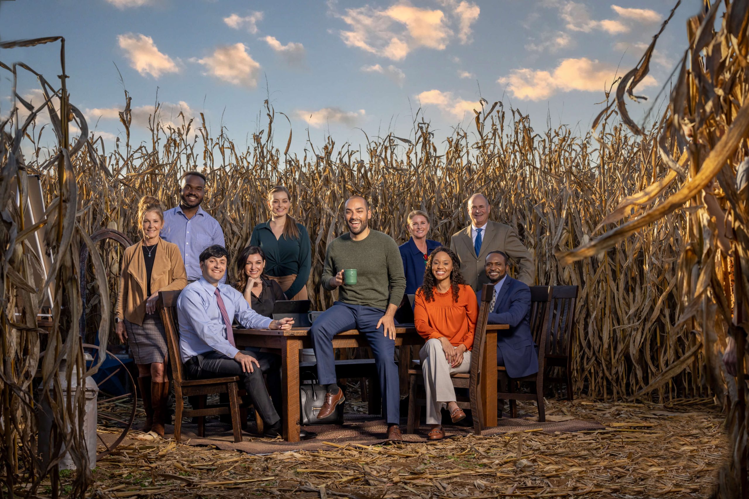 businessmen and women cheering in a cornfield