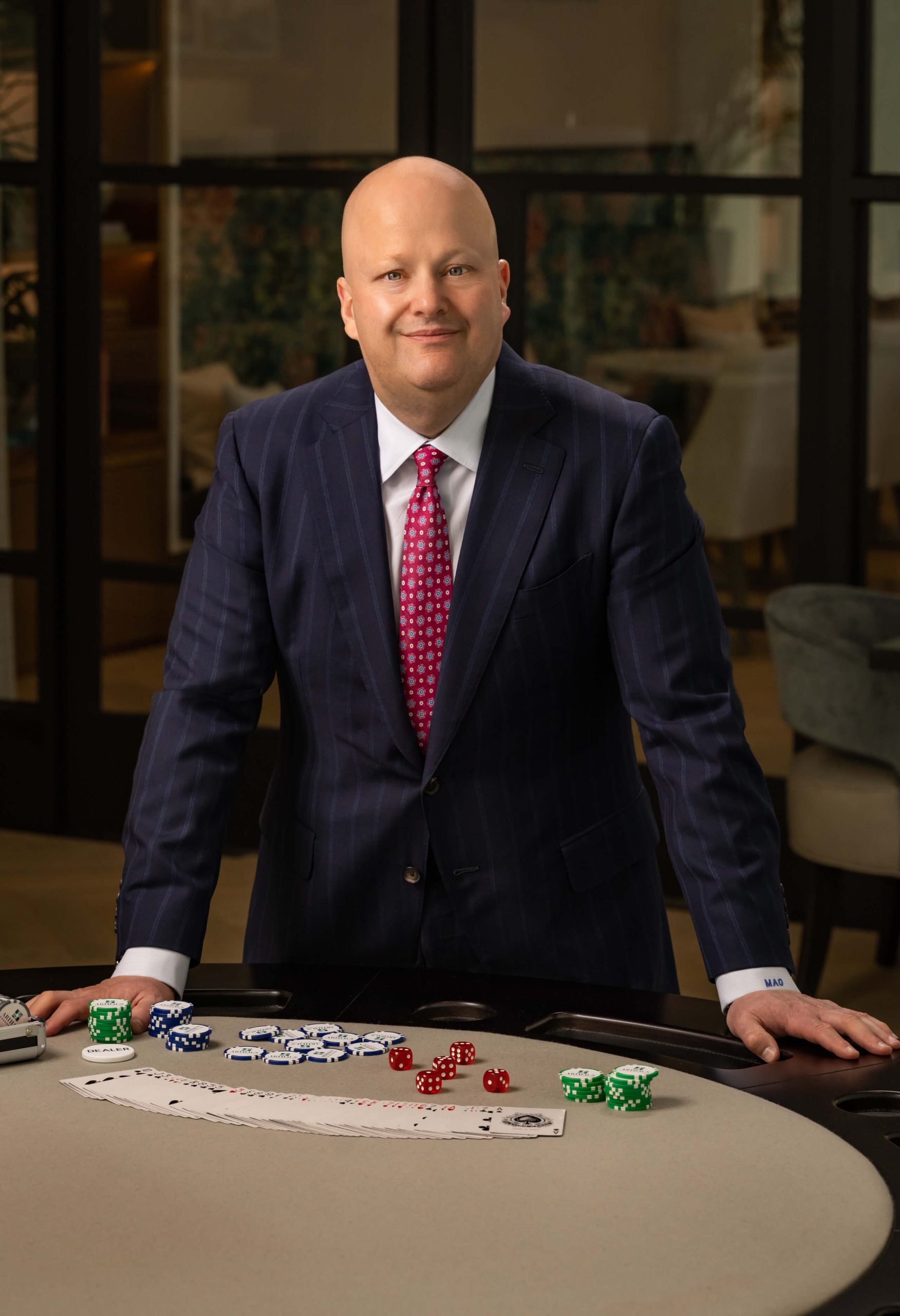 man in pinstripe suit at poker table