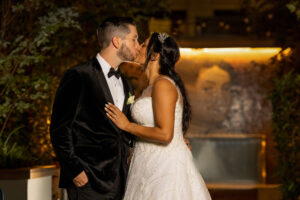 bride and groom kissing in secret garden space at w hotel philly