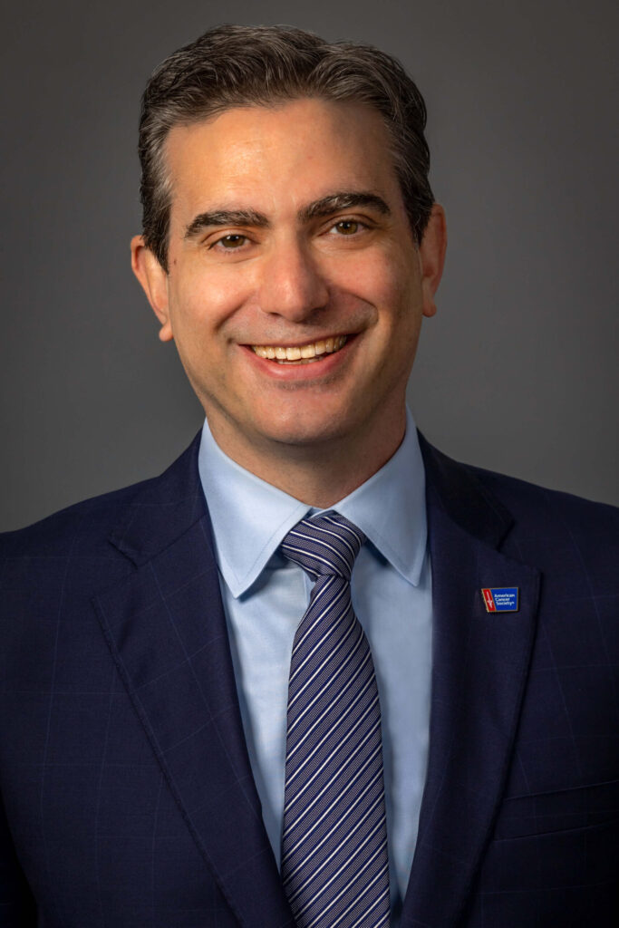 man with black and gray hair in blue suit