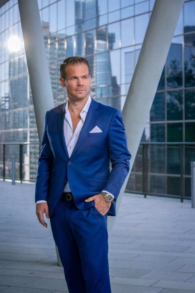 suave man in blue suit with city skyline reflection