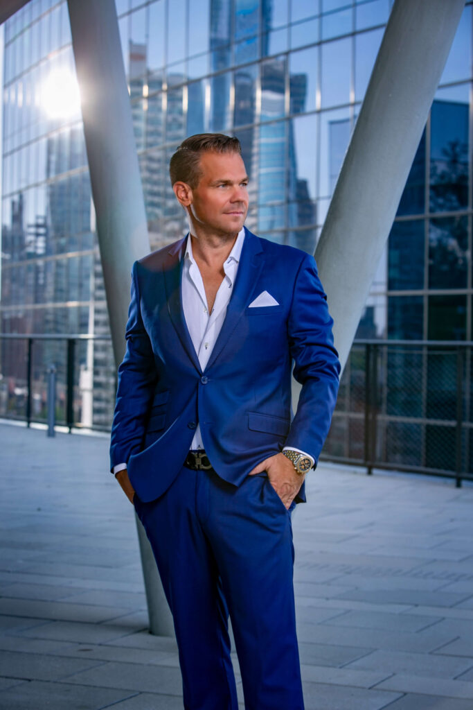 man in blue suit looking at skyline of philly
