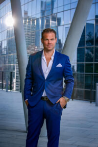man in royal blue suit with white button down