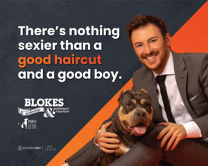 man in gray suit petting a dog