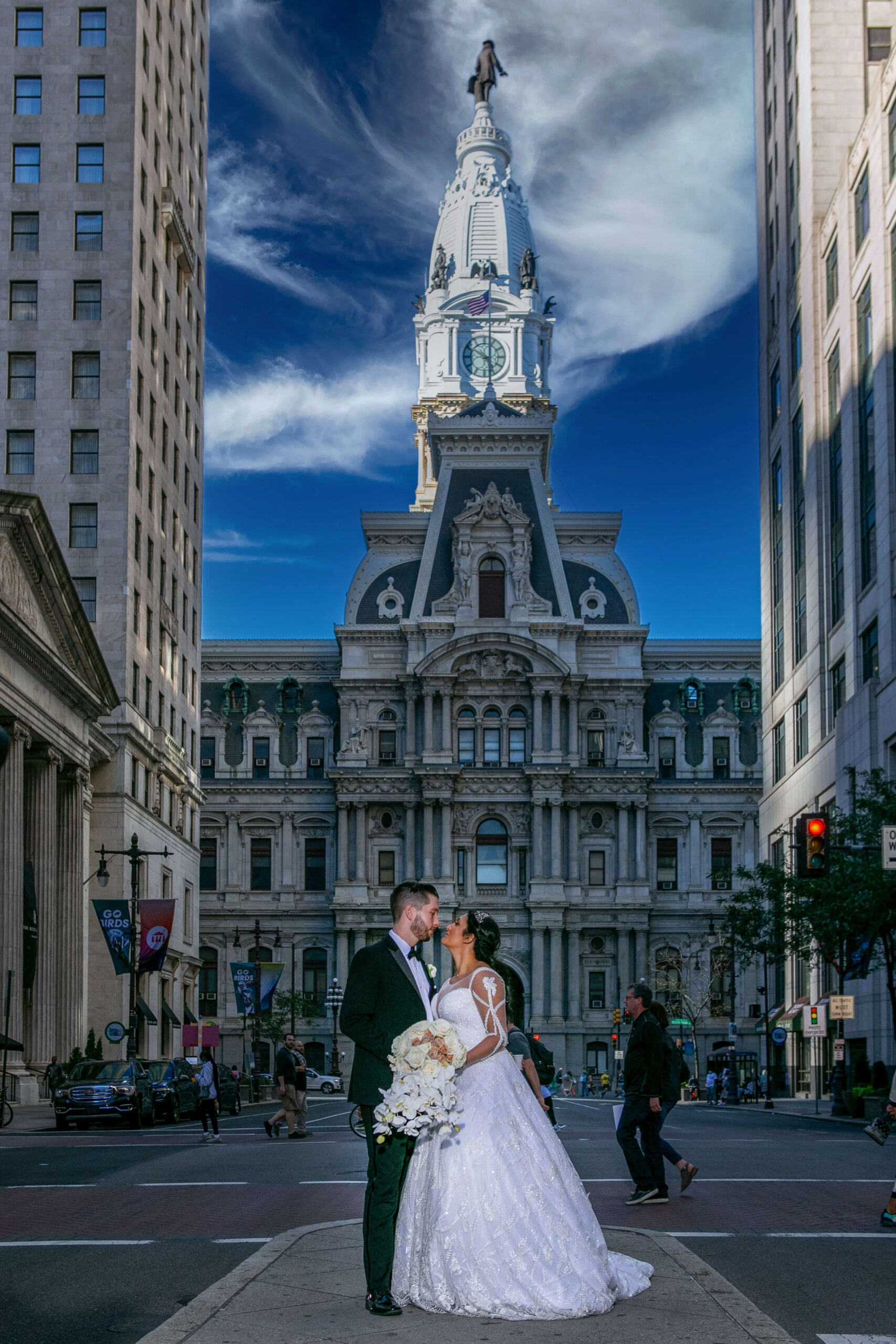 blue sky and clouds with bride and groom at philly city hall on wedding day