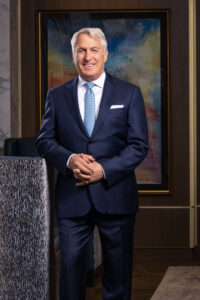 man in classic navy blue suit in elegant condo lobby