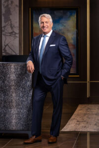 dapper man in a blue suit at the main lobby in the laurel