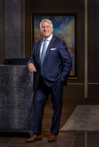 man in blue suit and light blue tie in luxury condo lobby