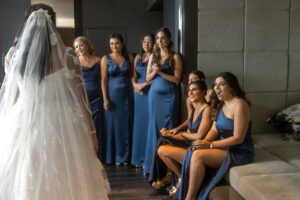 wedding dress reveal at w hotel suite in philly for bridesmaids in blue dresses