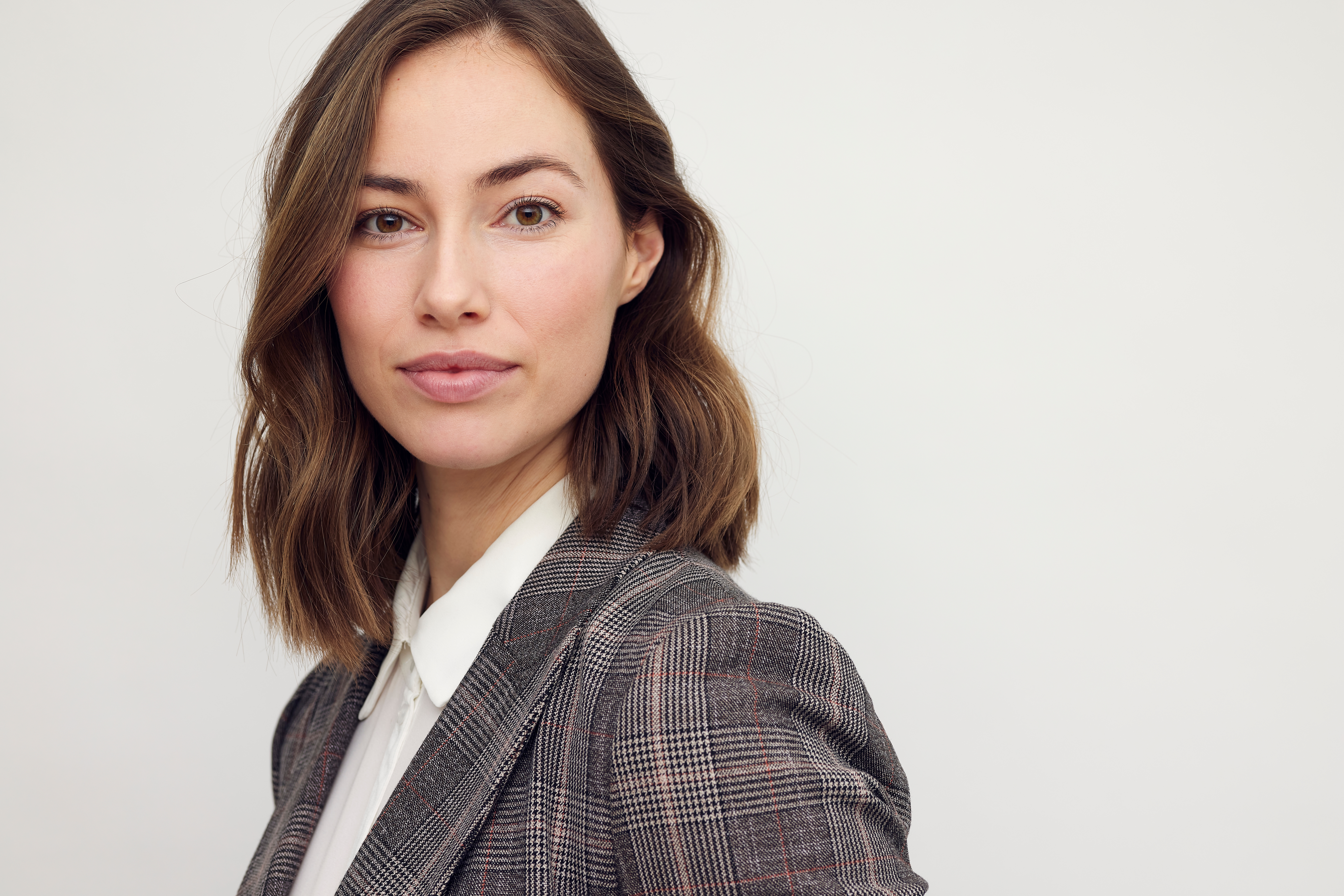 dr. alex vacarro in blue scrubs with hands on hips against black shutters