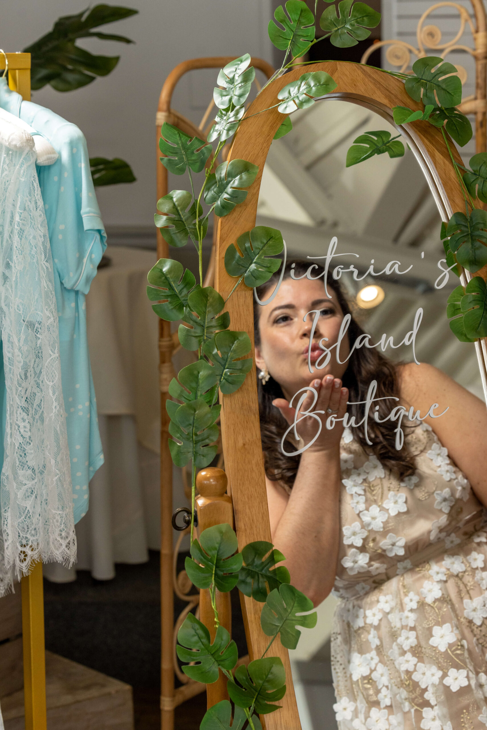 bride at tropical bridal shower blowing a kiss into full-length mirror