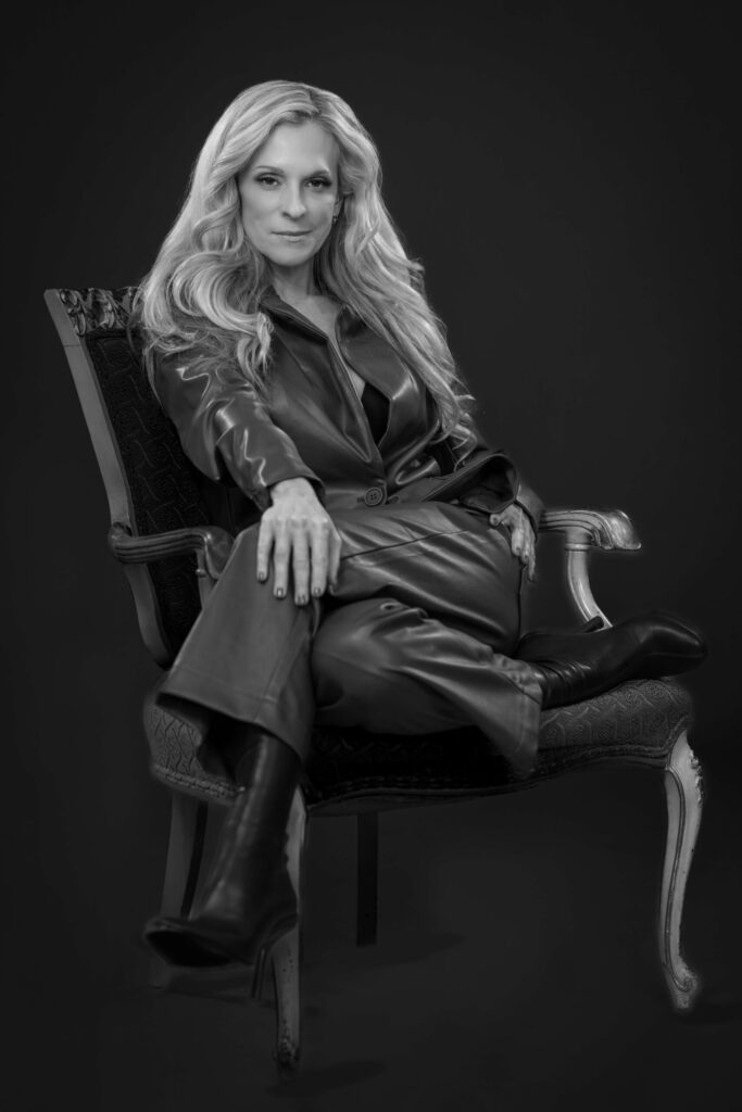 blonde woman sitting in a cool pose in an elegant chair