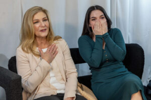 women sitting and reacting with positive energy and excitement