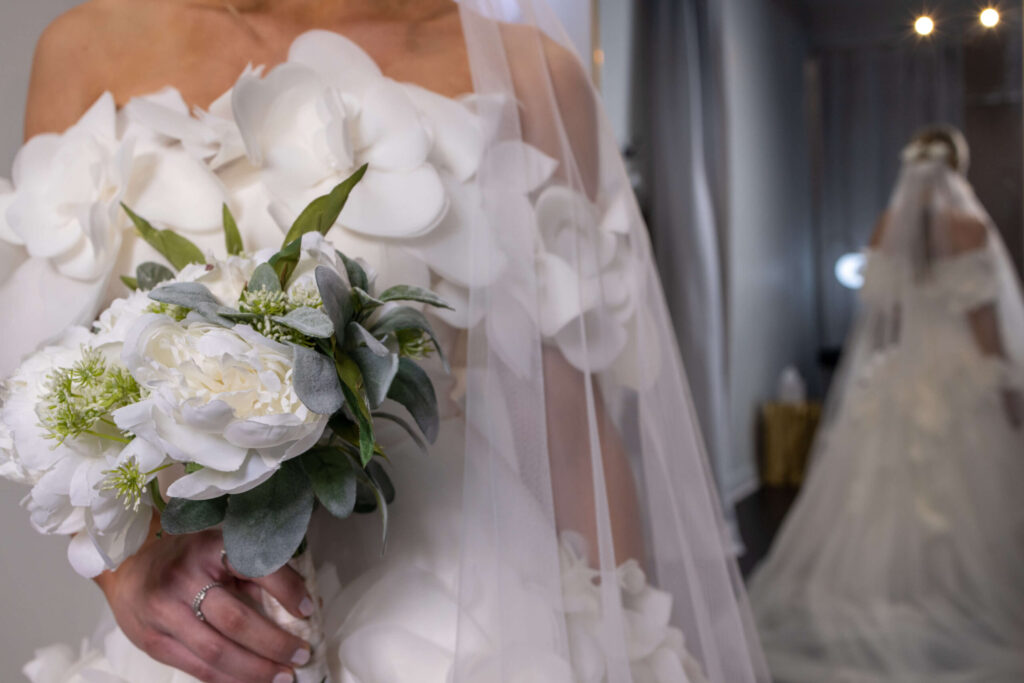 white wedding dress details and bouquet of flowers