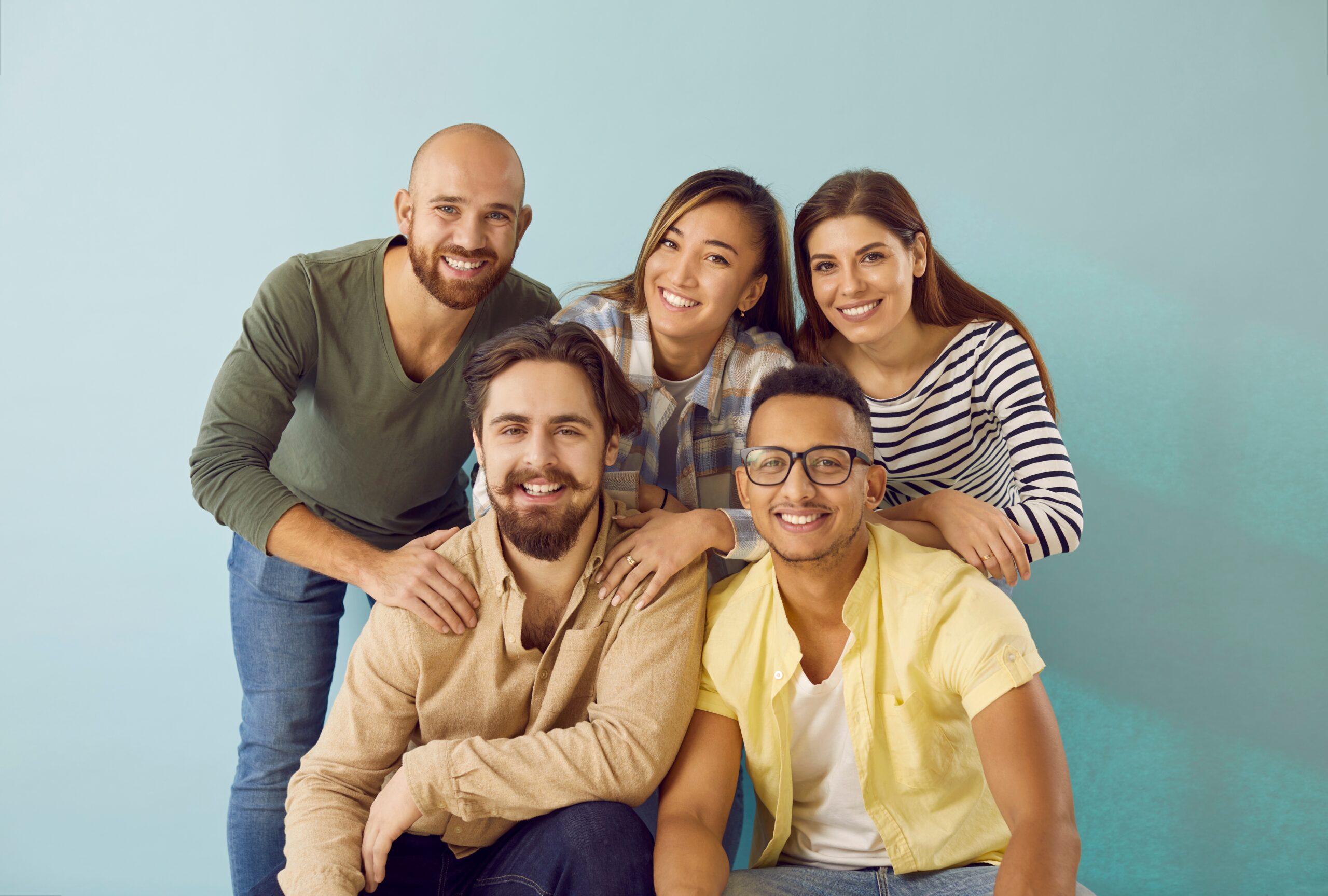 men and women in business casual suits posing in front of a stone country club