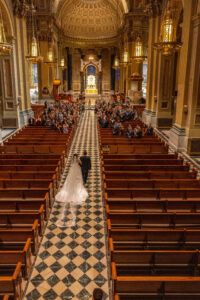 balcony shot of bride walking down aisle at saint peter and paul cathedral in philadelphia