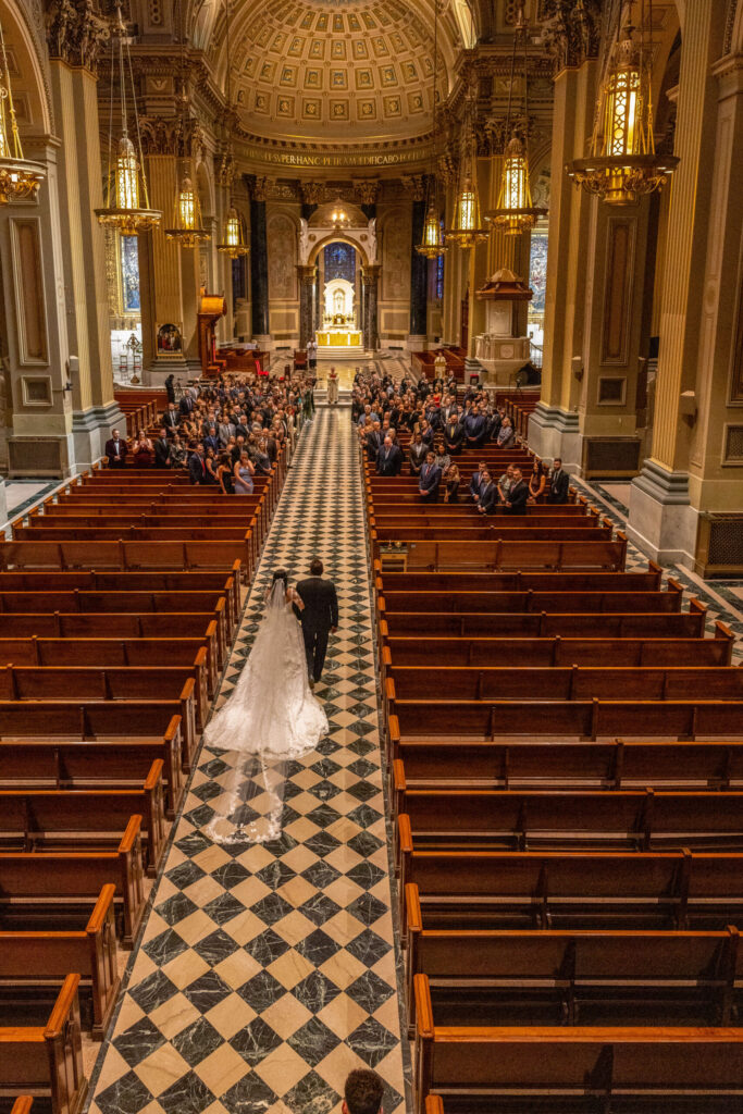 balcony shot of bride walking down aisle at saint peter and paul cathedral in philadelphia