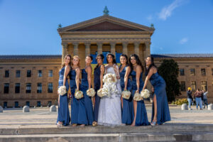 bridal party and bride at philadelphia museum of art during clear sky day