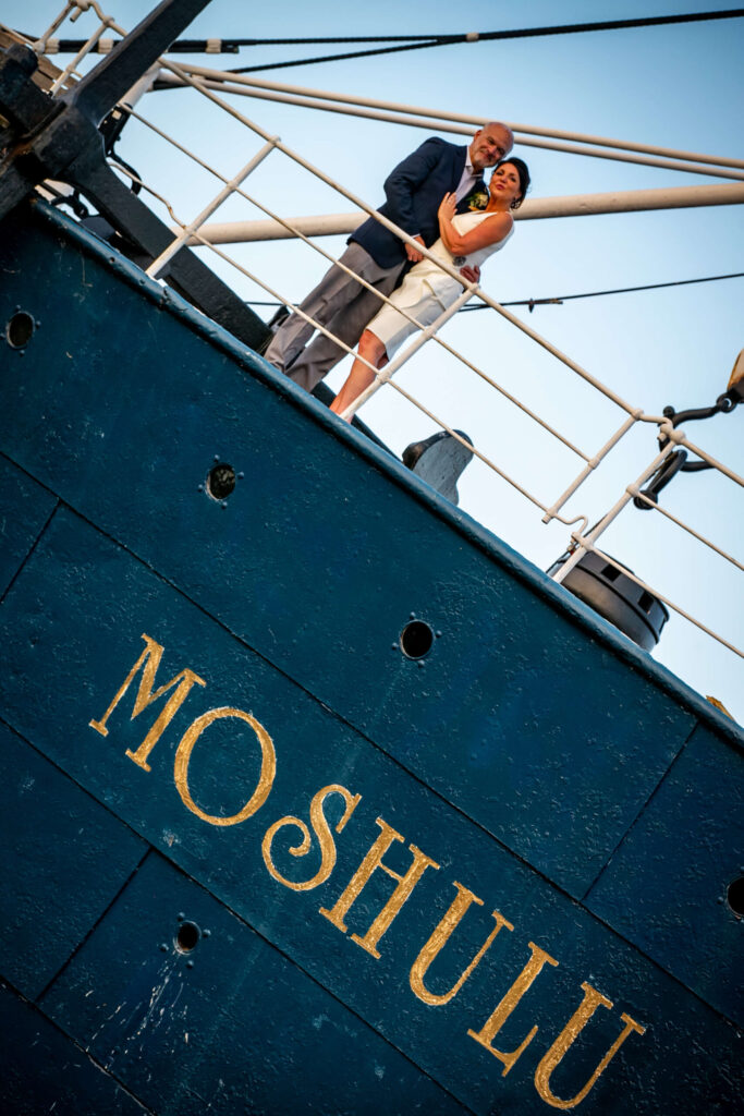 bride and groom posing aboard the moshulu in philly on their wedding day