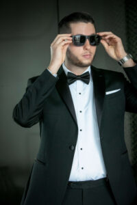 groom in tuxedo wearing sunglasses