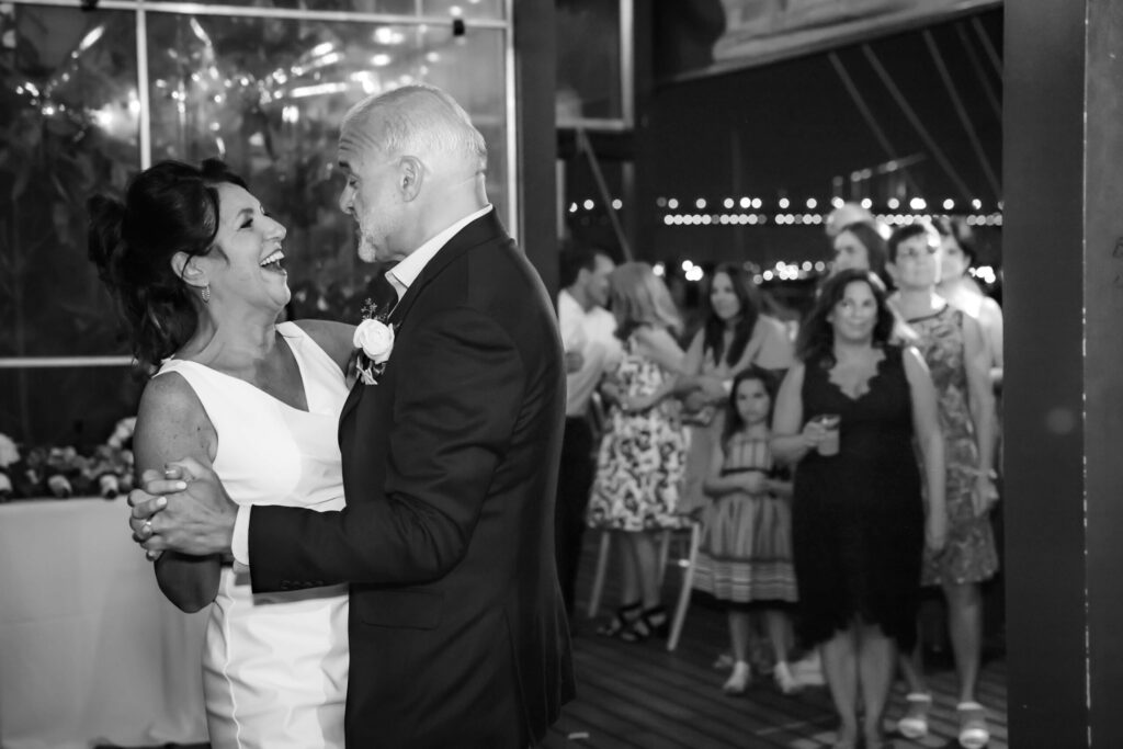 bride and groom dancing together and laughing at the moshulu
