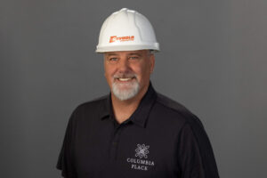 confident man smiling with a construction helmet on his head