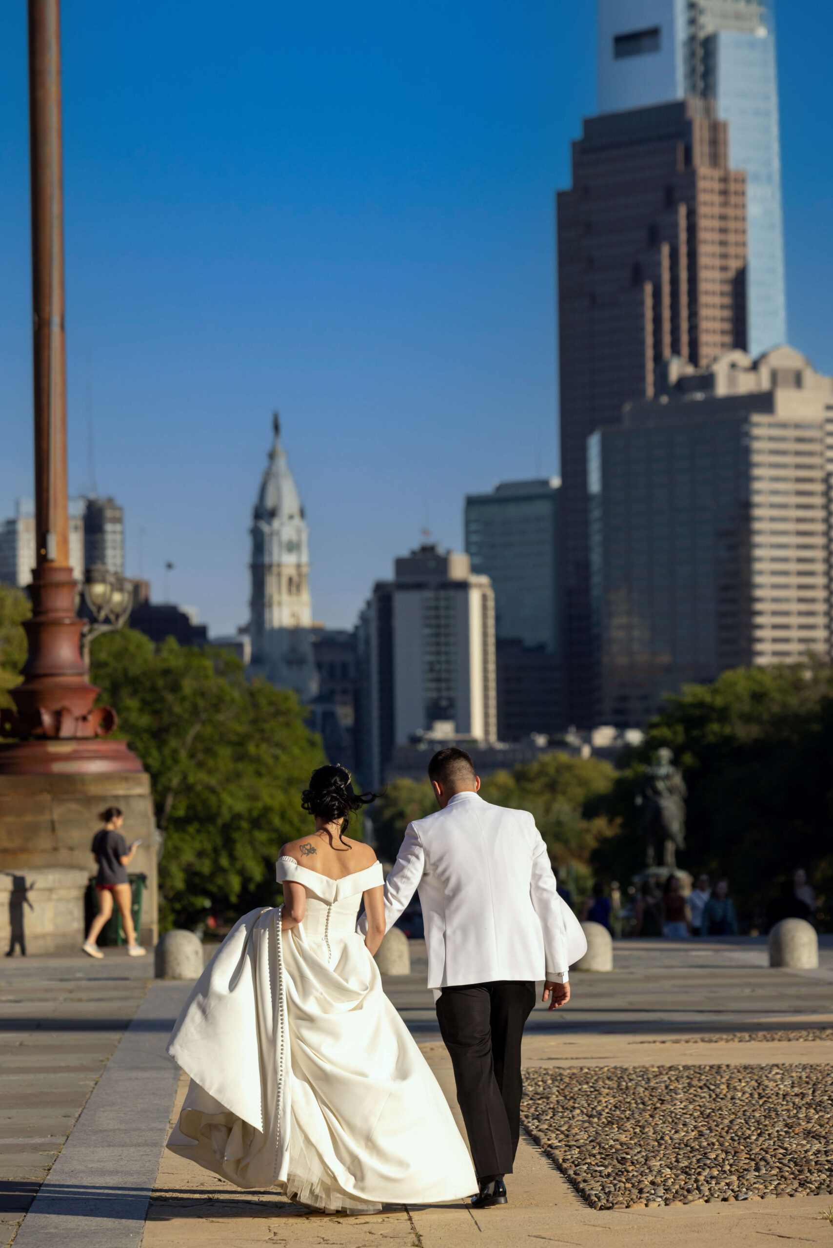 bride and groom walking at museum of art in philadelphia