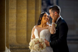 bride and groom romantically embracing one another at museum of art in philadelphia