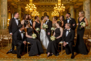 bride and groom kiss as the wedding party watches at the willard in dc