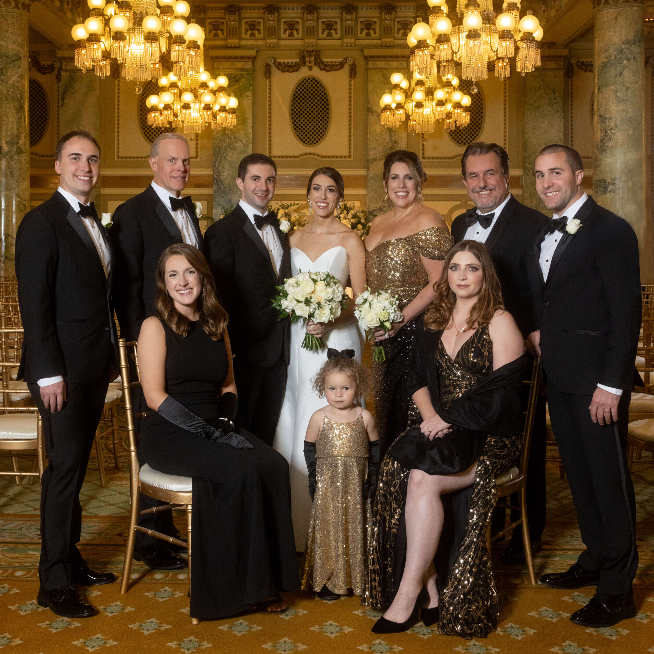 family posing with bride and groom in glamorous wedding ceremony room at the willard