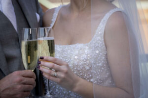 bride and groom clinking their champagne glasses together