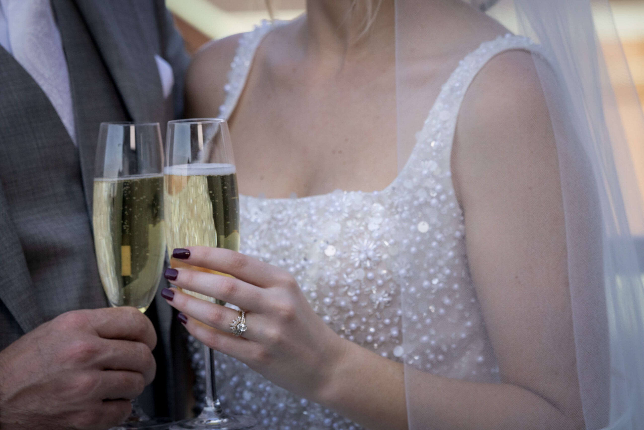bride and groom clinking their champagne glasses together