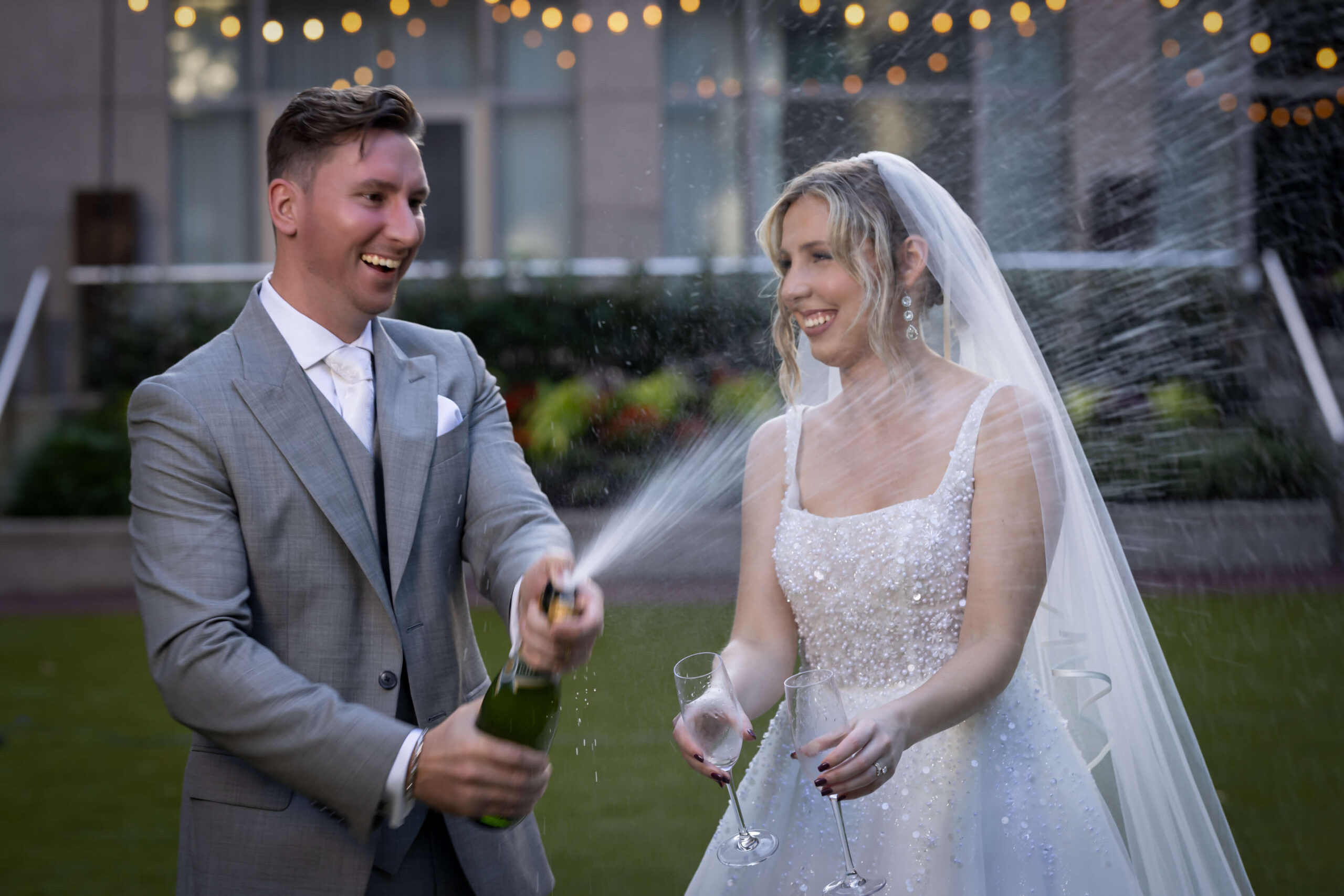 young bride and groom popping champagne at the logan hotel in philadelphia