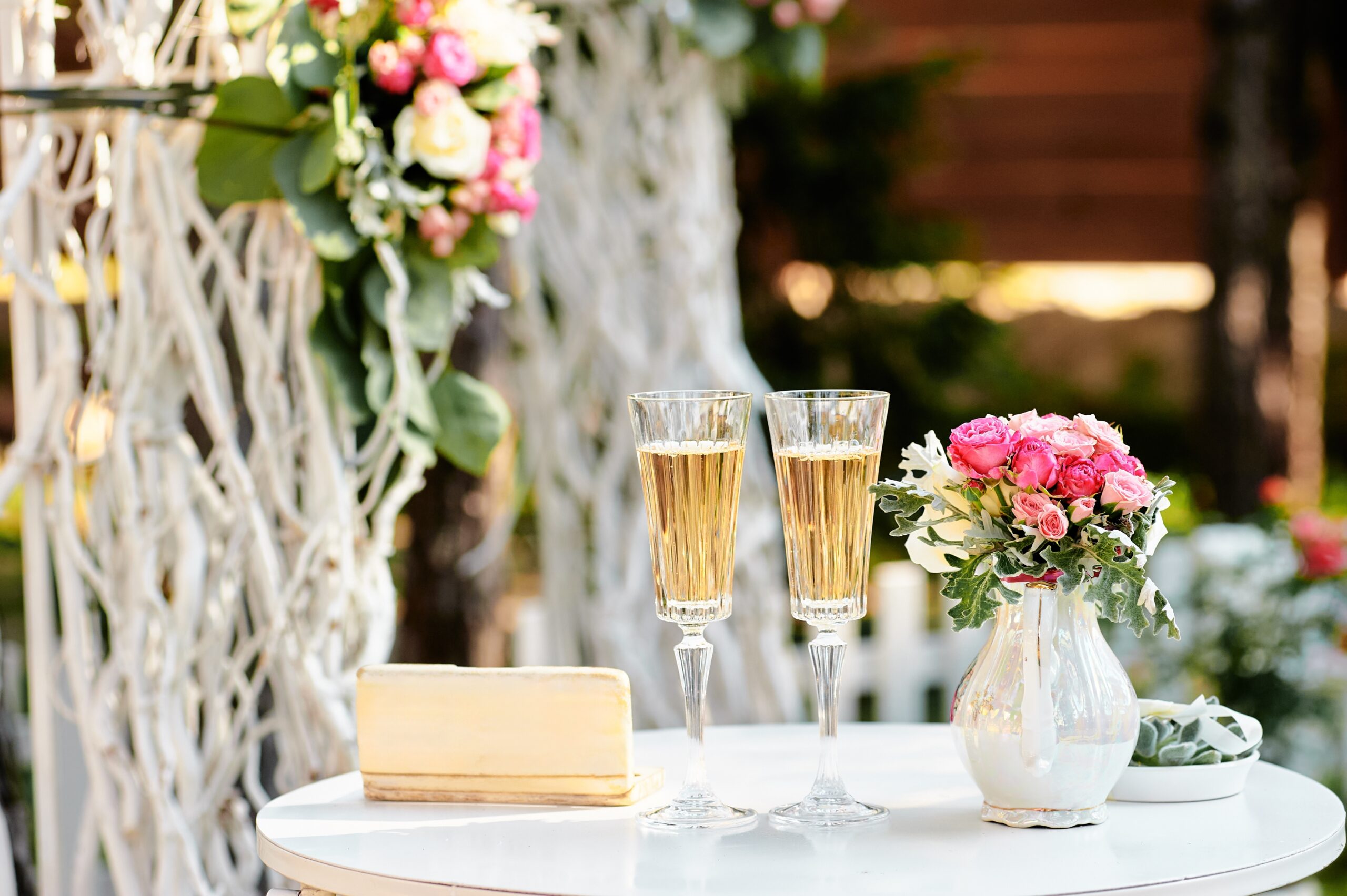 cheerful bride and groom toast with champagne glasses in the courtyard at the logan