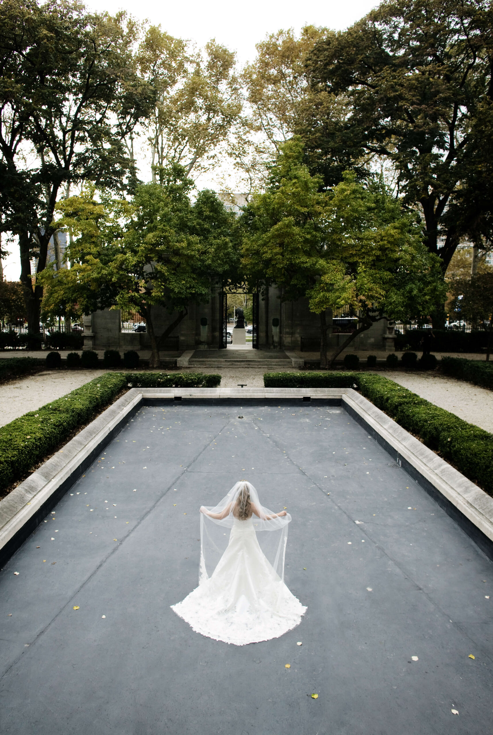 bride standing in the reflection pond at the rodin museum in philadelphia