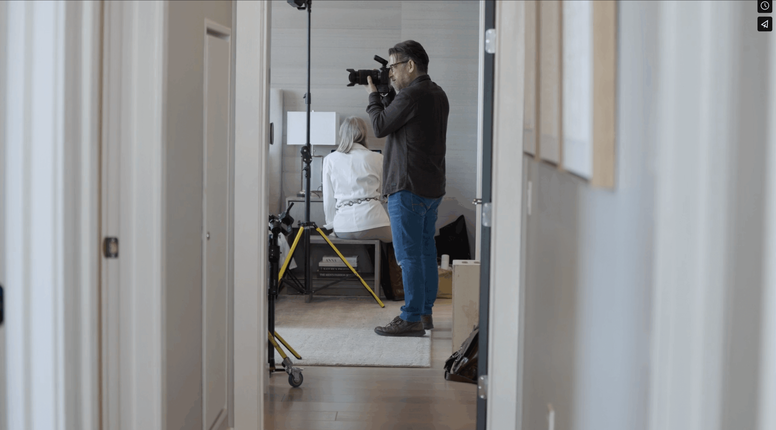 a bride and groom pose for a photo with their grandmother in an extravagant ceremony room
