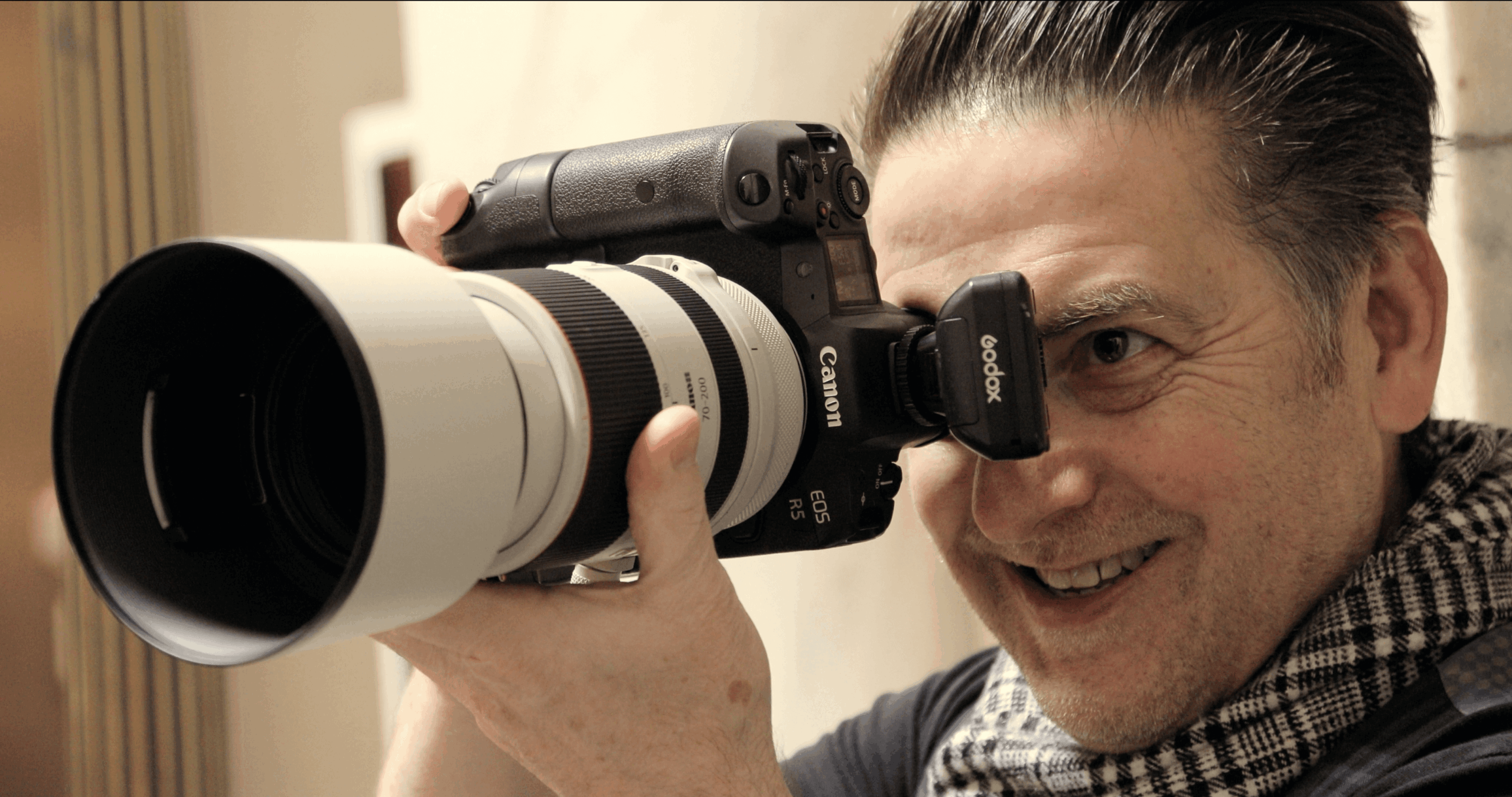 a bride and groom pose with their family at their outdoor wedding in a garden