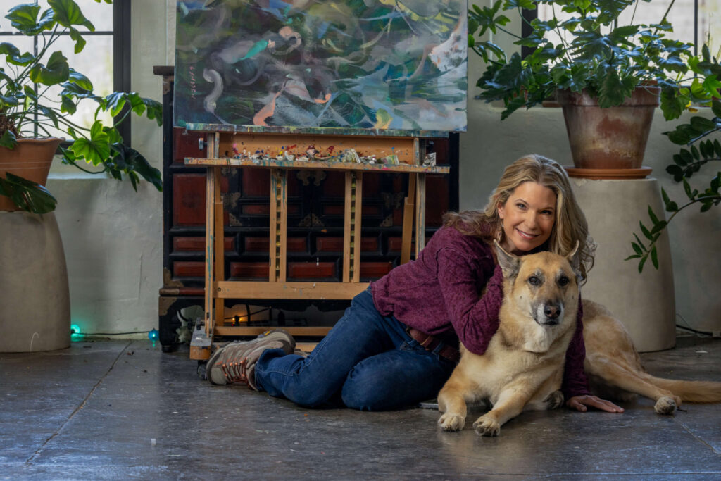 blonde woman and german shepherd dog posing in an art studio
