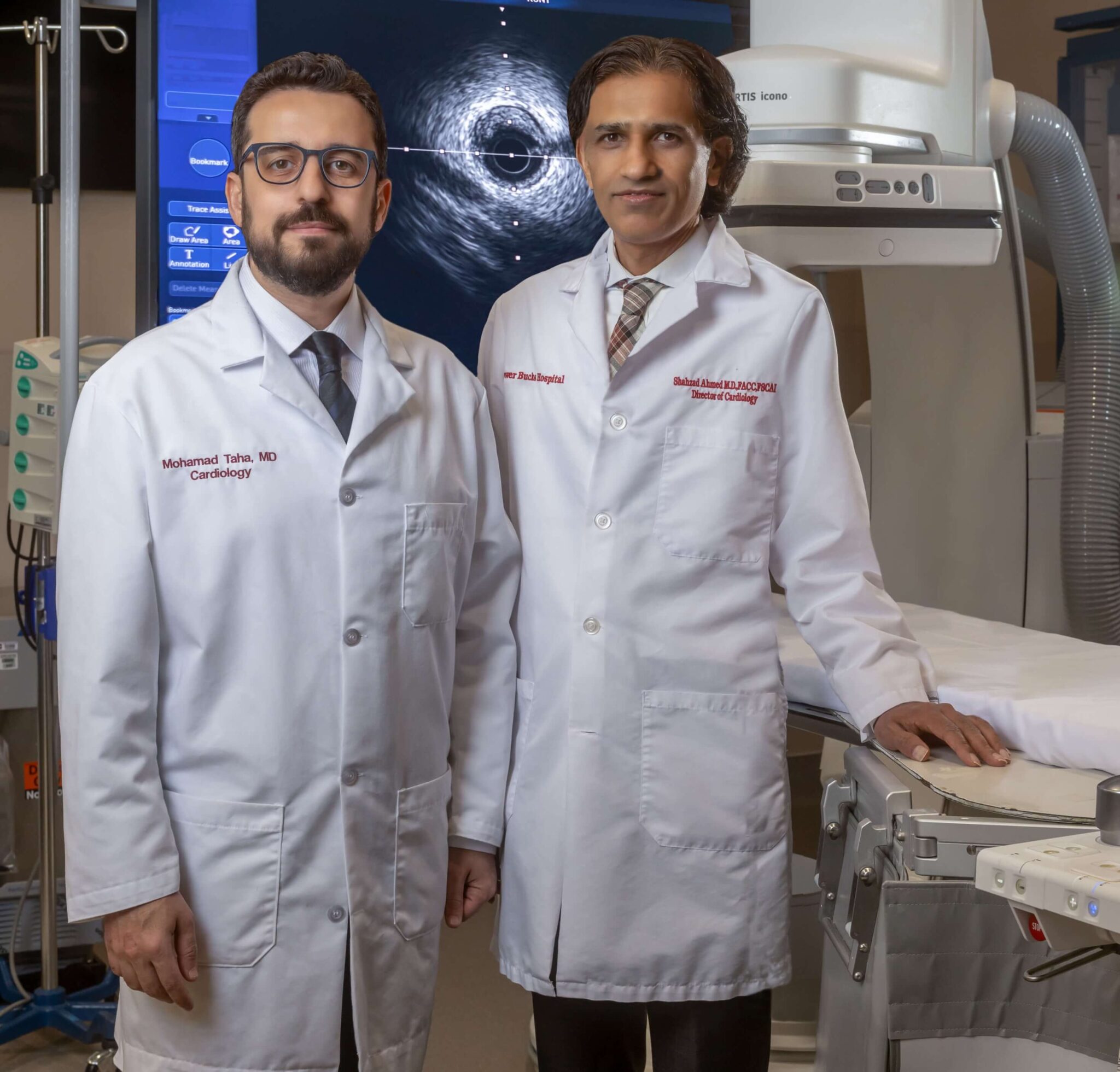 cardiologist doctors in white lab jackets posing in an operation room