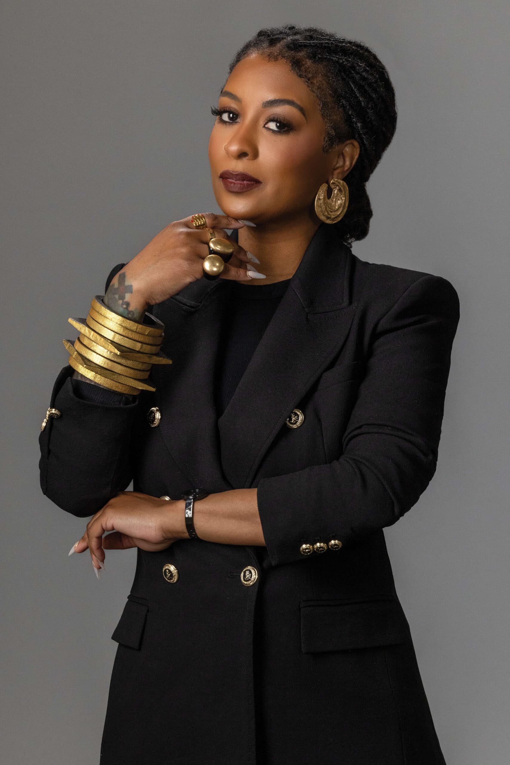 fashion headshot photo of a glamorous woman in gold jewelry