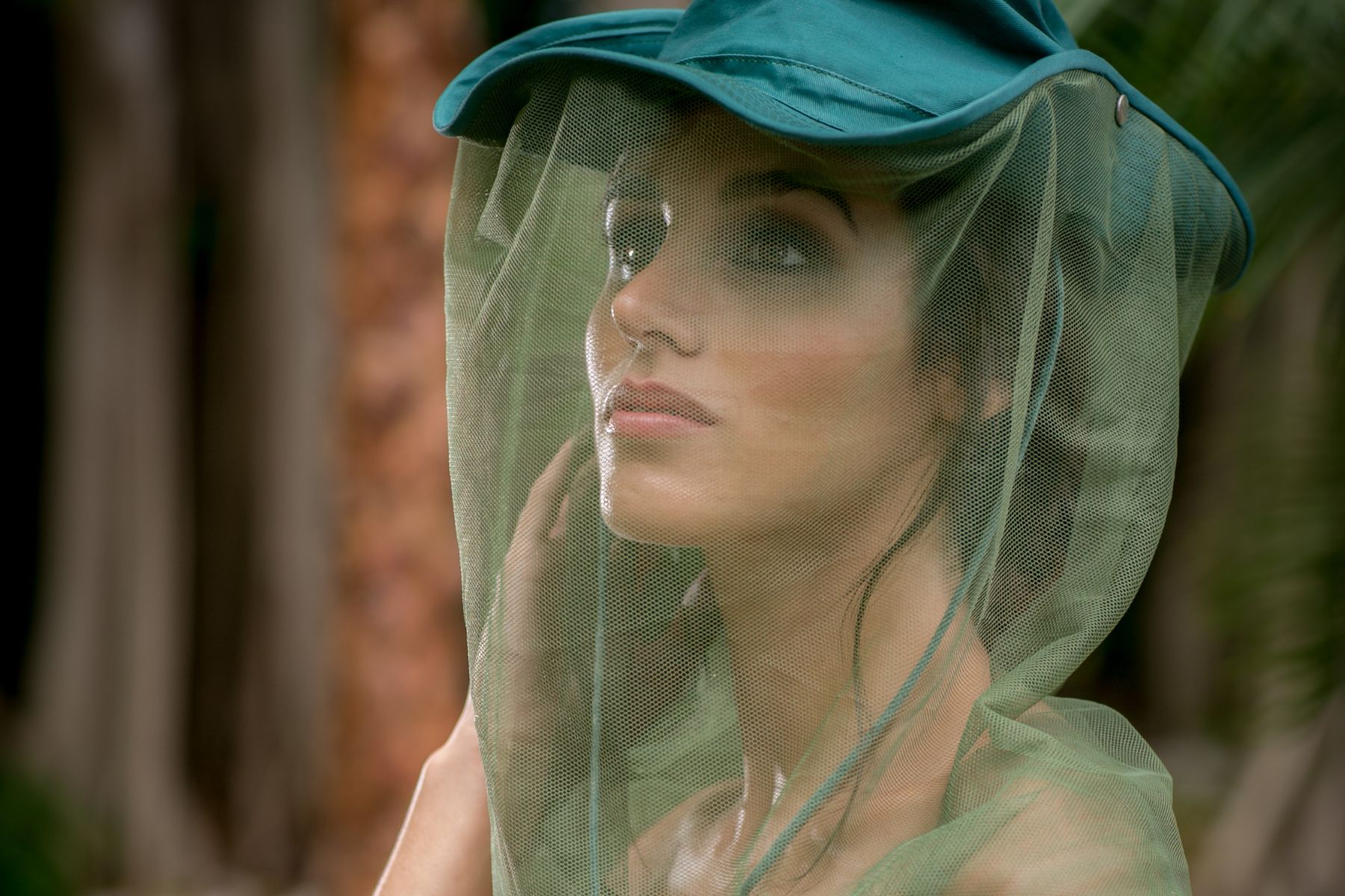 woman wearing stylish green mosquito bug hat for fashion photo shoot at redland farm in miami florida