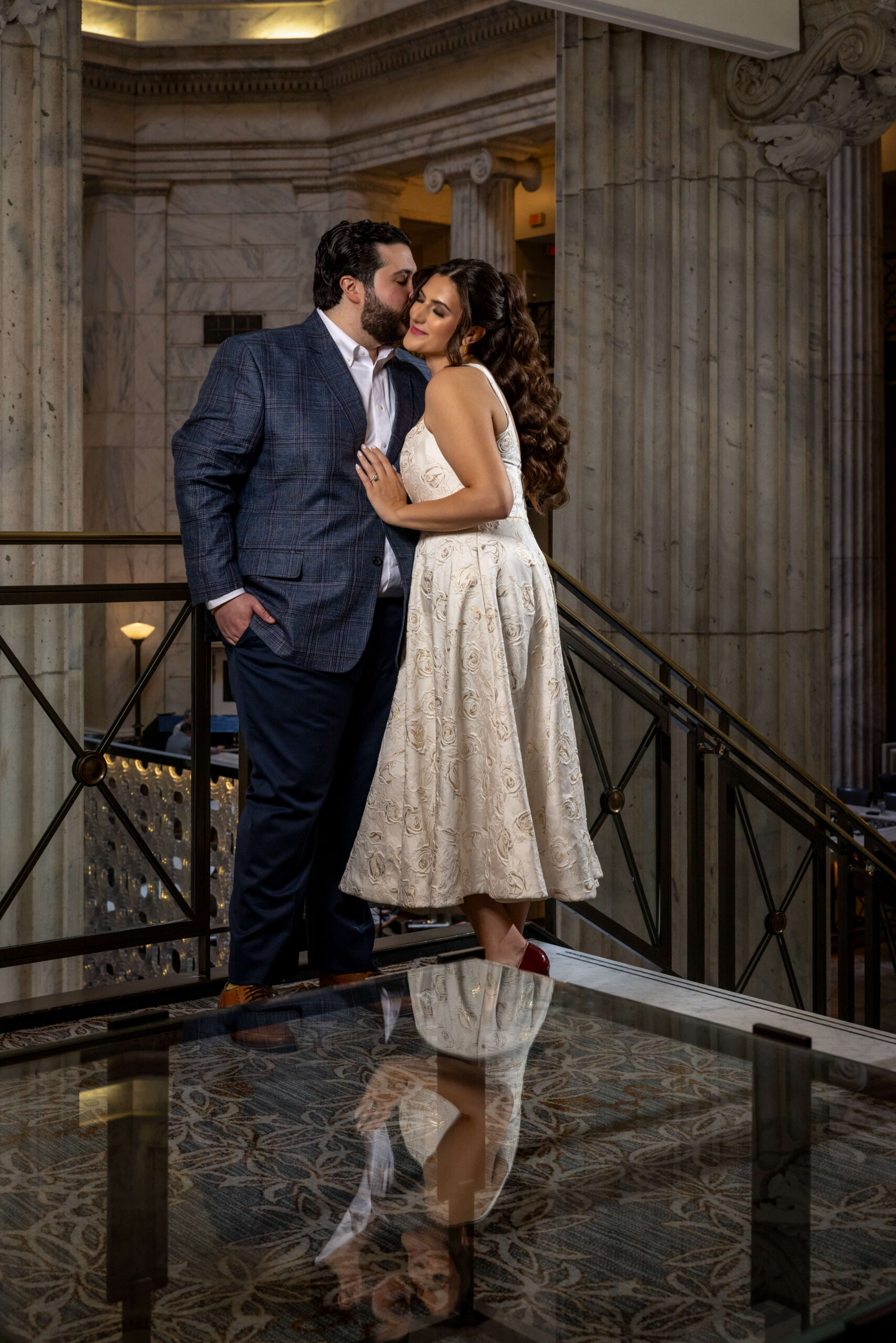engaged couple embracing one another inside of the ritz carlton main lobby in philadelphia