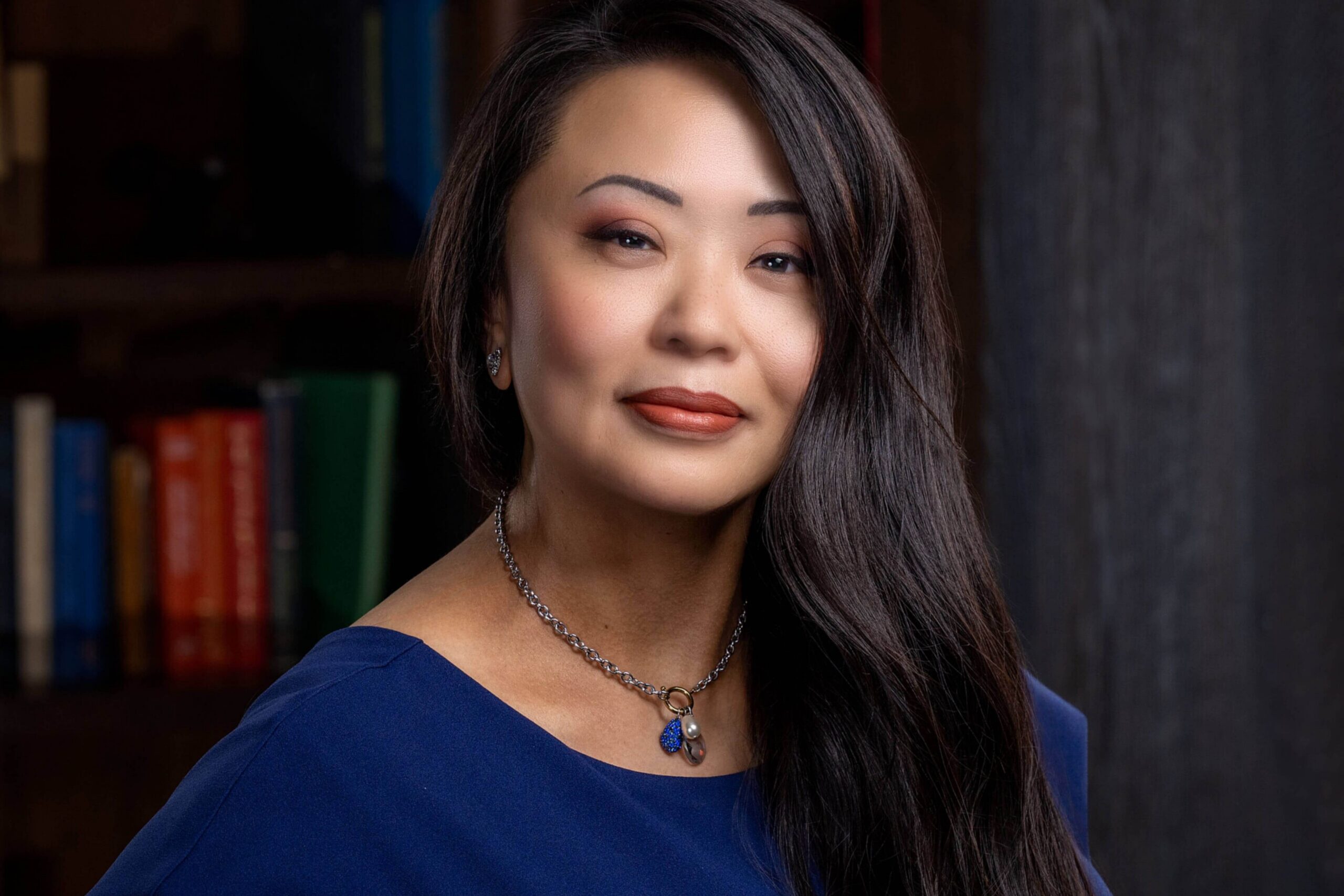headshot photography of woman in modern library setting