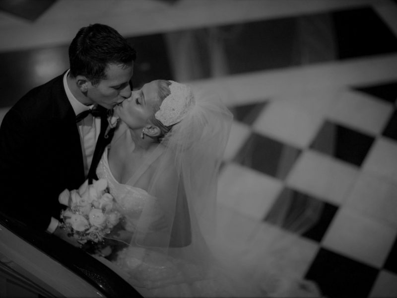 bride and groom kissing on stairs