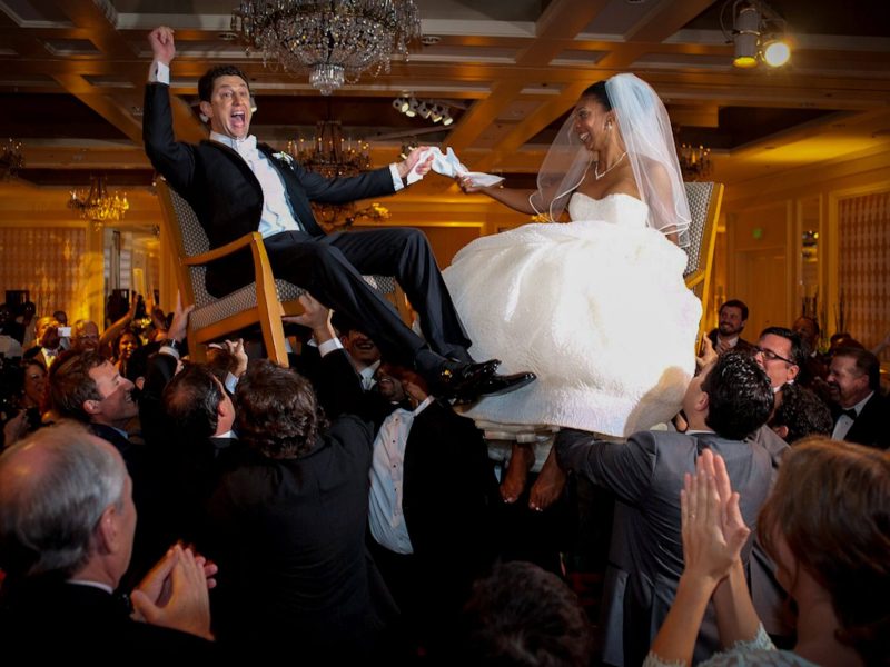 exciting jewish horrah wedding tradition with bride and groom