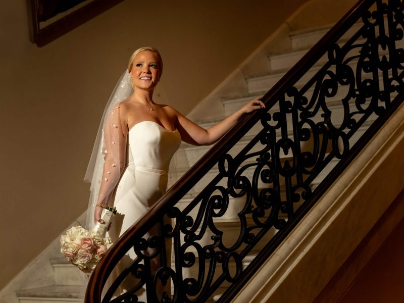 bride in wedding dress at stairs