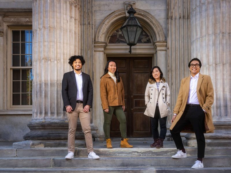 four stylish friends at column building