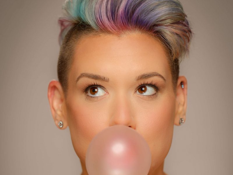 woman blowing a bubble with gum
