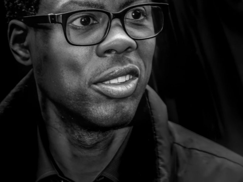 chris rock wearing black glasses and coat